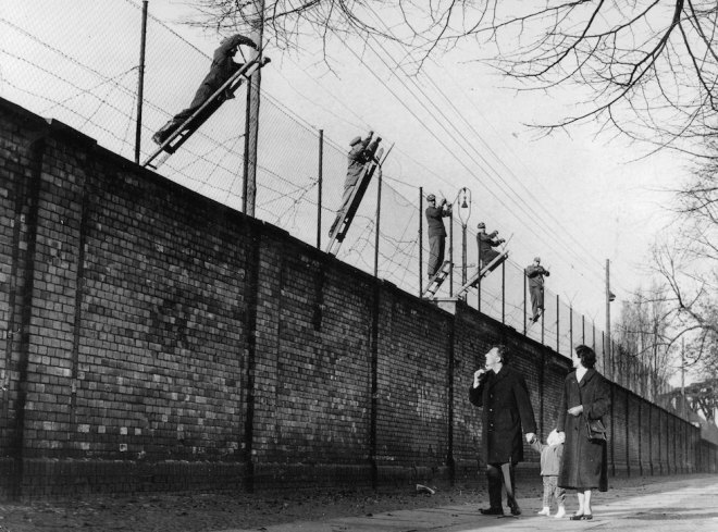 Berlin, Germany, 19th November, 1961, East Berlin border guards adding barbed wire to the newly built Berlin Wall, The wall was set up the Soviet army to prevent refugees escaping from the Soviet sector in the East to West Berlin (Photo by Popperfoto/Getty Images)
